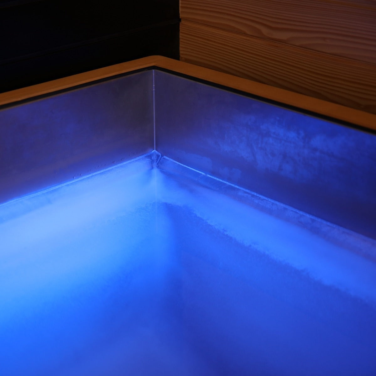 corner of cold plunge with blue lighting